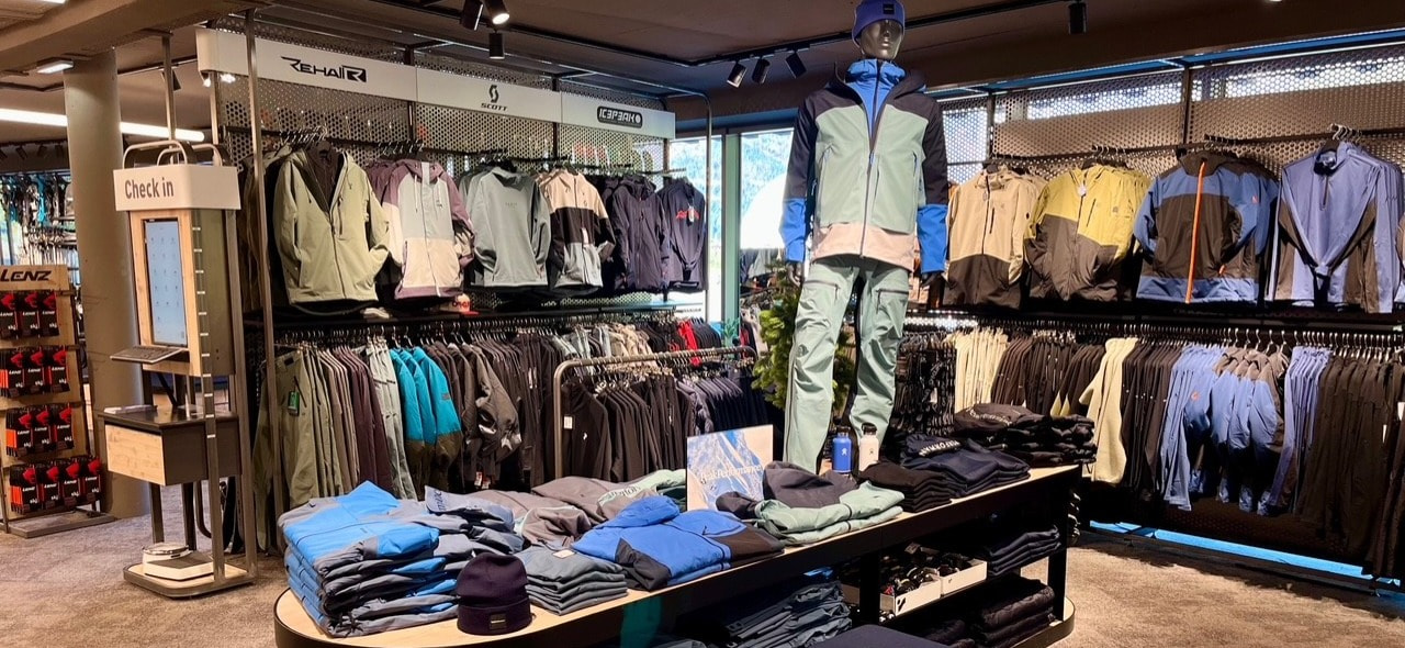 Interior of a clothing store featuring outdoor apparel and a mannequin display.